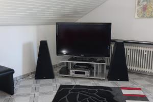 a living room with a flat screen tv and speakers at Seeblick Kampf mit Fahrradgarage in Nonnenhorn