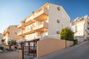 a building with balconies on the side of a street at Studio Apartment Tia in Makarska
