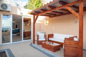 a patio with a white couch and a table at Studio Apartment Tia in Makarska