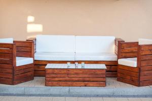 a couch with two chairs and a coffee table at Studio Apartment Tia in Makarska