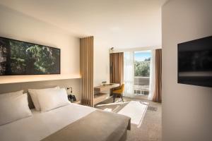 Кровать или кровати в номере Eden Hotel by Maistra Collection