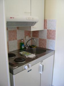 a kitchen with a sink and a stove at Anna Studios in Katapola
