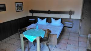 a bedroom with a bed and a table with a candle on it at Landhaus im kühlen Grunde Garni in Pracht