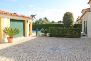 a patio with a star on the ground in front of a house at Spacious Villa in Azeitão (with private pool) in Azeitao