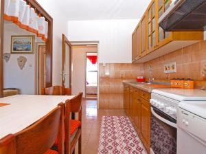 een keuken met houten kasten en een aanrecht bij Apartment Snezana 1200 in Fažana