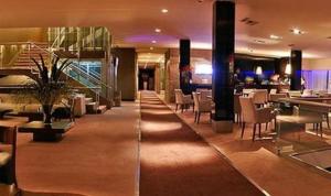 a lobby of a hotel with tables and chairs at Virgo Hotel & Spa in Las Lenas