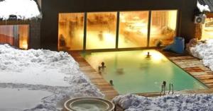a group of people in a swimming pool in the snow at Virgo Hotel & Spa in Las Lenas