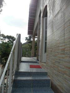 un escalier menant à un bâtiment avec un tapis rouge dans l'établissement Casas de Temporada Conservatória, à Conservatória