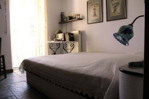 a bedroom with a bed and a lamp on the wall at Villa Kiriaki in Gavrion +35 photos