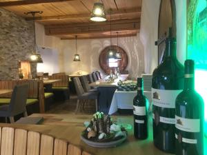 two bottles of wine sitting on a table in a restaurant at Württembergischer Hof in Kirchheim unter Teck