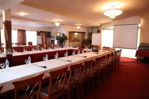 a conference room with a long table and chairs at Hotel Millenium in Bitola