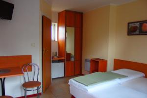 sypialnia z łóżkiem, biurkiem i krzesłem w obiekcie Patio Apartamenty i Pokoje w mieście Niechorze