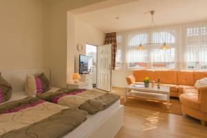 a living room with two beds and a couch at Villa Anna in Ostseebad Sellin