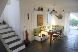a living room with a table and a green couch at Villa Kiriaki in Gavrio