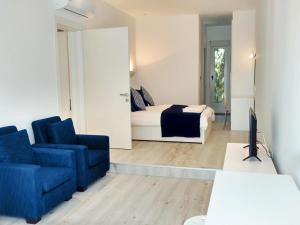 a living room with a bed and a couch and a tv at Olosuites in Limassol