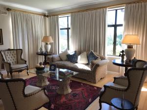 a living room with a couch and chairs and a table at Edens Guest House in Durban