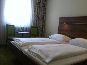 Postel nebo postele na pokoji v ubytování Hotel Hauser an der Universität
