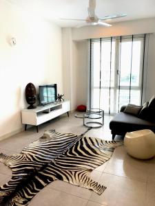 a living room with a zebra rug on the floor at Afiniti Residences in Johor Bahru