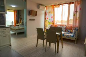 a kitchen and dining room with a table and chairs at Studios Grace - Port Tsarevo in Tsarevo