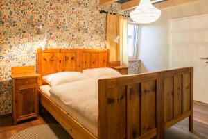 a bedroom with a wooden bed in a room at Südalpen Lofts in Bleiburg