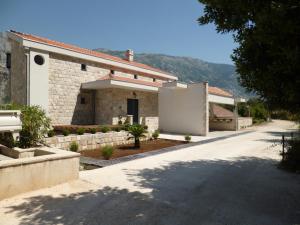 a house with a road leading to a driveway at Villa "M Family" in Kotor