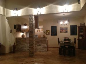 a living room with a stone fireplace and a table at Villa "M Family" in Kotor