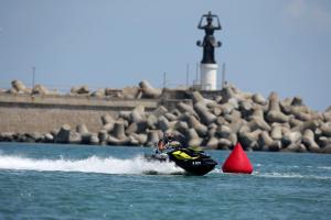 a person on a jet ski in the water at Studios Grace - Port Tsarevo in Tsarevo