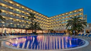 a hotel with a large pool in front of a building at H10 Vintage Salou - Adults Only in Salou