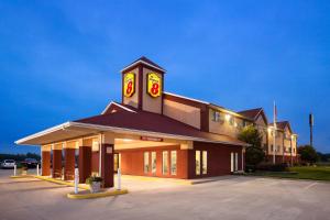 a large building with a clock tower in a parking lot at Super 8 by Wyndham Salem in Salem