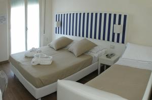 A bed or beds in a room at Mini Hotel