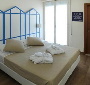 A bed or beds in a room at Mini Hotel