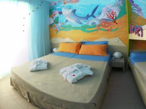 A bed or beds in a room at Mini Hotel