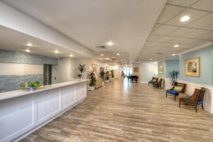a lobby of a hospital with a long hallway with chairs at Bahama House - Daytona Beach Shores in Daytona Beach