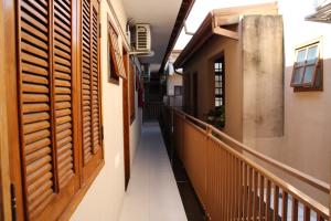 a hallway of a house with wooden shutters at Hotel Reimann in Indaiatuba