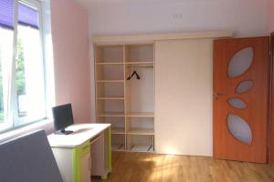 a room with a desk with a computer on it at Apartament Monika in Sopot +4 photos