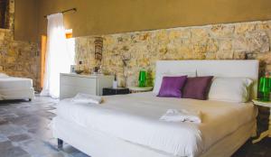 Un pat sau paturi într-o cameră la Borgo Alveria