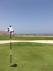 a checkered flag on a golf course at Apartment in Jebel Sifah in As Sīfah