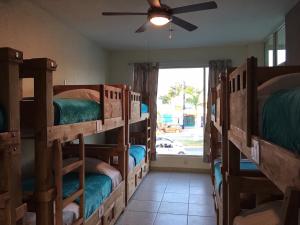 a room with a bunch of bunk beds at Hostal Bucerias in Bucerías
