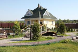 a house with a playground in front of it at Family Complex Zastava u Oki in Velegozh