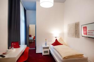 Säng eller sängar i ett rum på Hotel Mille Stelle City