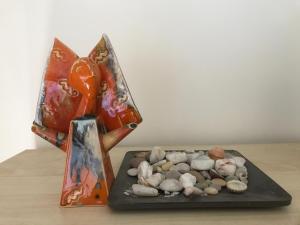 a vase with rocks on a table next to at Pervalka 13-5 in Pervalka
