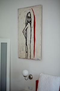 a drawing of a woman hanging on a wall at Rooms Zagreb 17 in Zagreb