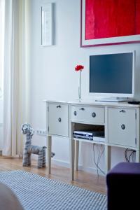 a white dresser with a television on top of it at Rooms Zagreb 17 in Zagreb