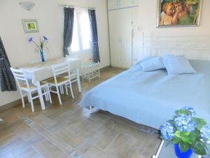 ein Schlafzimmer mit einem Bett und einem Tisch und Stühlen in der Unterkunft Holiday Home Villa Bella in Vrsar