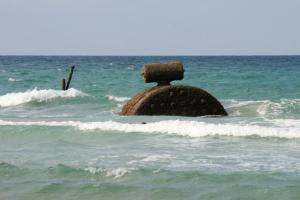 a rock in the ocean in the water at Hospederia Doña Lola Zahara in Zahara de los Atunes