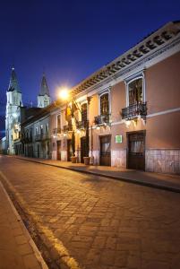 an empty street in a town at night at Hotel Boutique Santa Lucia in Cuenca