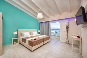 a bedroom with a bed and a large window at Onar Corfu Aparts & Studios in Ipsos
