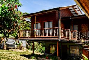 a house with a balcony on the side of it at Pension Santa Elena in Monteverde Costa Rica