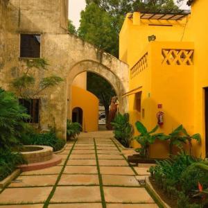 an entrance to an old building with an archway at Bungalows Demetria in Guadalajara