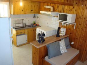a small kitchen with a sink and a microwave at Three Bedroom Country House in Magoúla